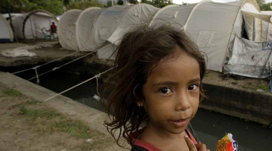 An East Timorese child refugee walks near her camp in Dili February 18, 2008.