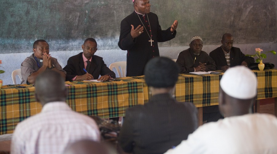 Bangui's Archbishop Dieudonne Nzapalainga (centre) and Imam Kobine Layama (right) address Muslims during a peace and reconciliation meeting in Bangassou