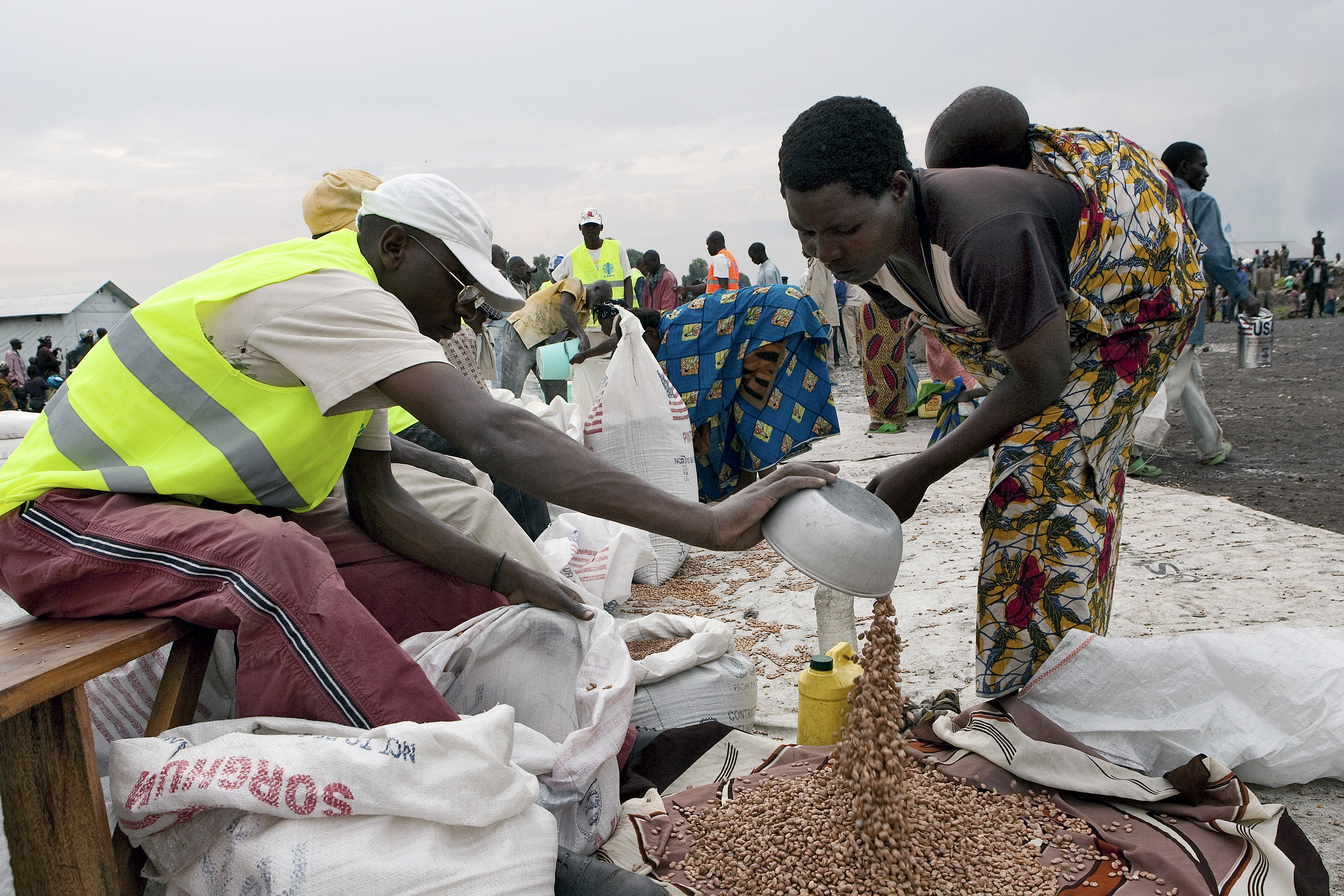 WFP Officer Distributes Food Ration