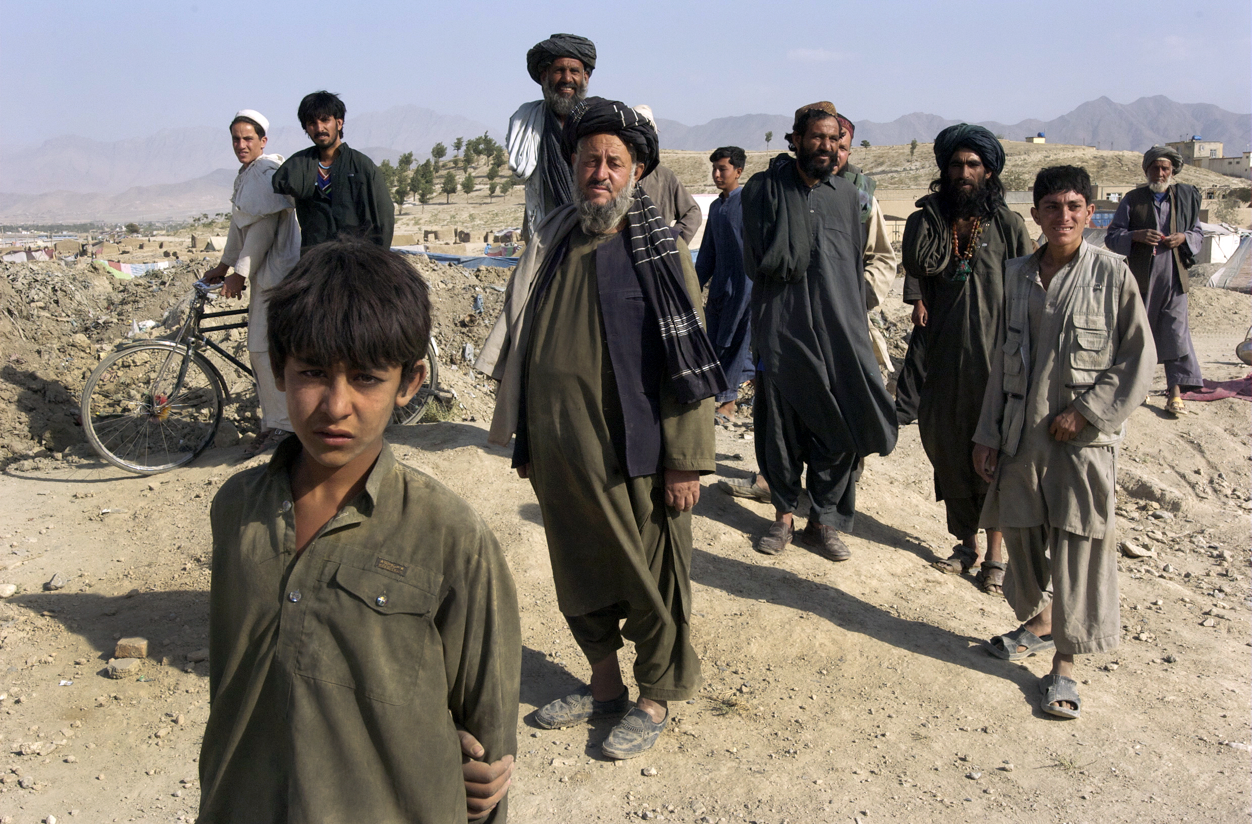 A group of Kuchi nomads walk through their camp in Bagram, Afghanistan.