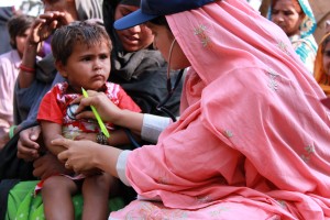 A doctor examines a young boy at a mobile health clinic in Pakistan