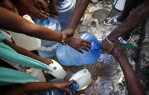 Haitians jostle to fill containers with water after the earthquake in downtown Port-au-Prince January 17, 2010