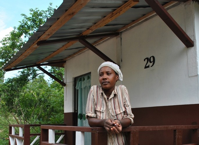 A woman stands in her new house, a transitional shelter built in the rural areas near Grand Goave.