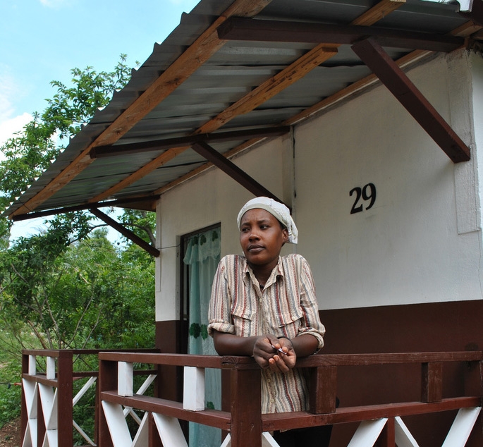 A woman stands in her new house, a transitional shelter built in the rural areas near Grand Goave.