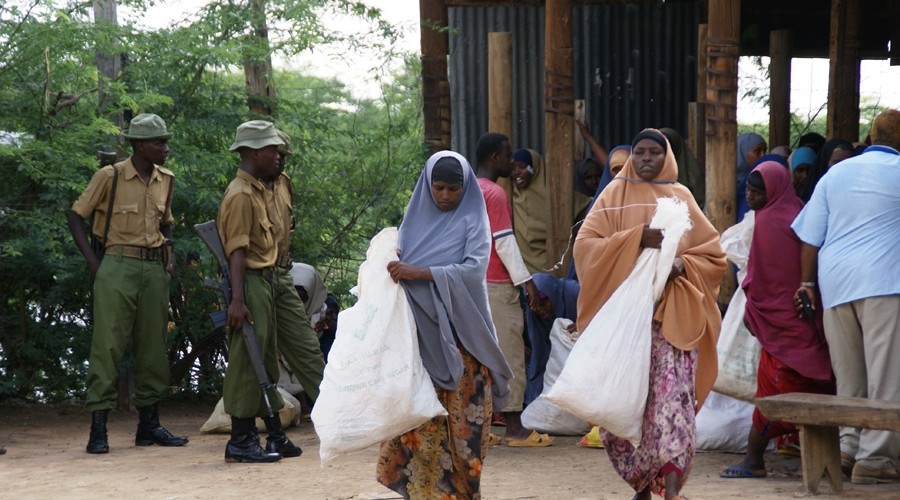Police guard a food distribution in Ifo Camp
