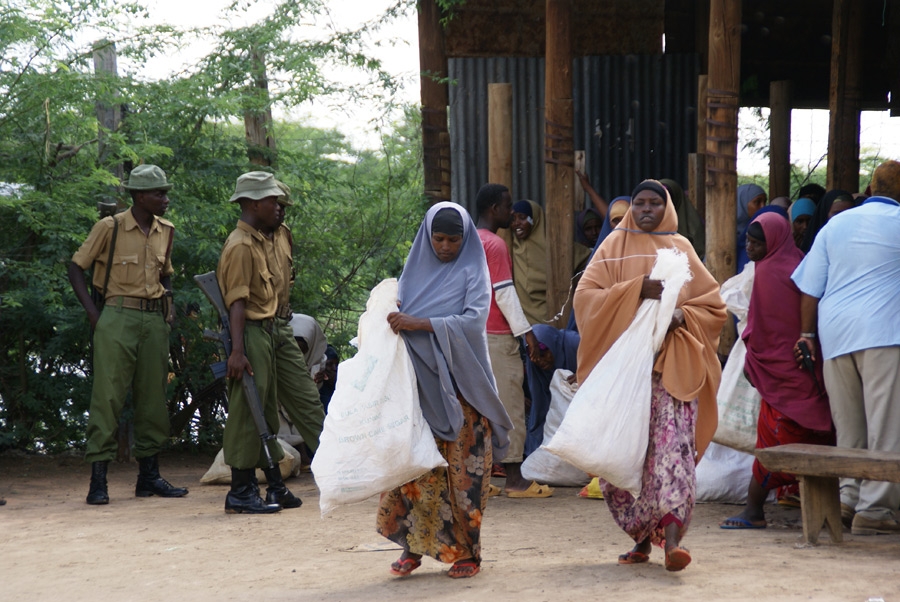 Police guard a food distribution in Ifo Camp
