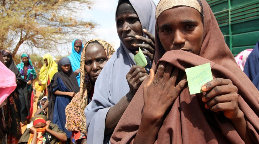 Women queue to receive assistance in Kenya