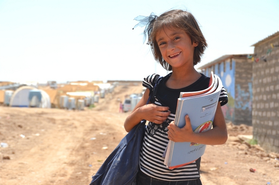 A Syrian Kurdish refugee child comes back from school in Domiz refugee camp in Iraqi Kurdistan