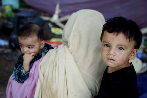 Displaced by floods in Pakistan, a family rests in a makeshift shelter