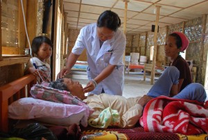 A doctor treats an elderly patient at the Je Yang IDP camp, Kachin State