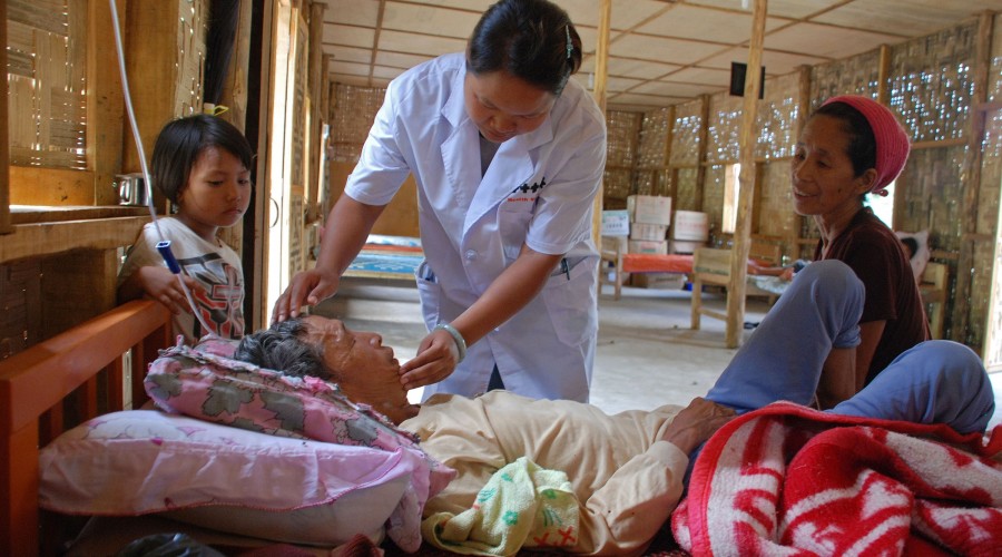 A doctor treats an elderly patient at the Je Yang IDP camp, Kachin State