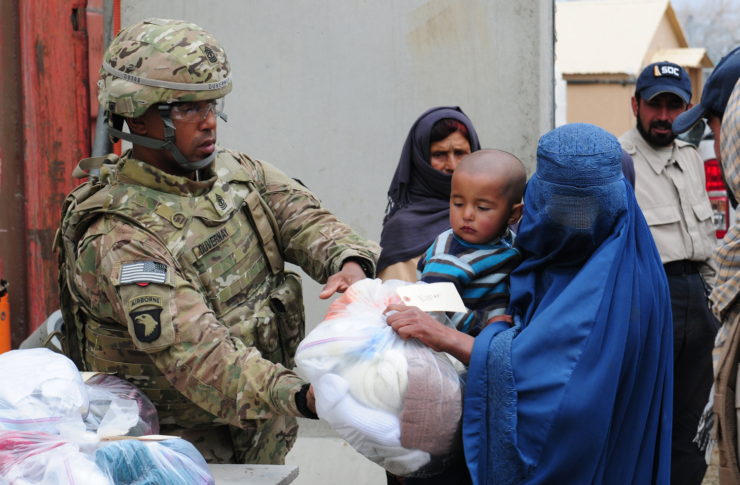 A US soldier distributing clothing at El Salam Egyptian Field Hospital, Bagram Air Field, Afghanistan, March 2012