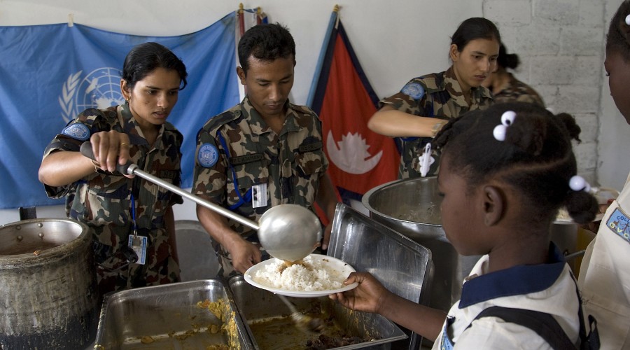 UN peacekeepers serve food to people displaced by the earthquake in Haiti in January 2010
