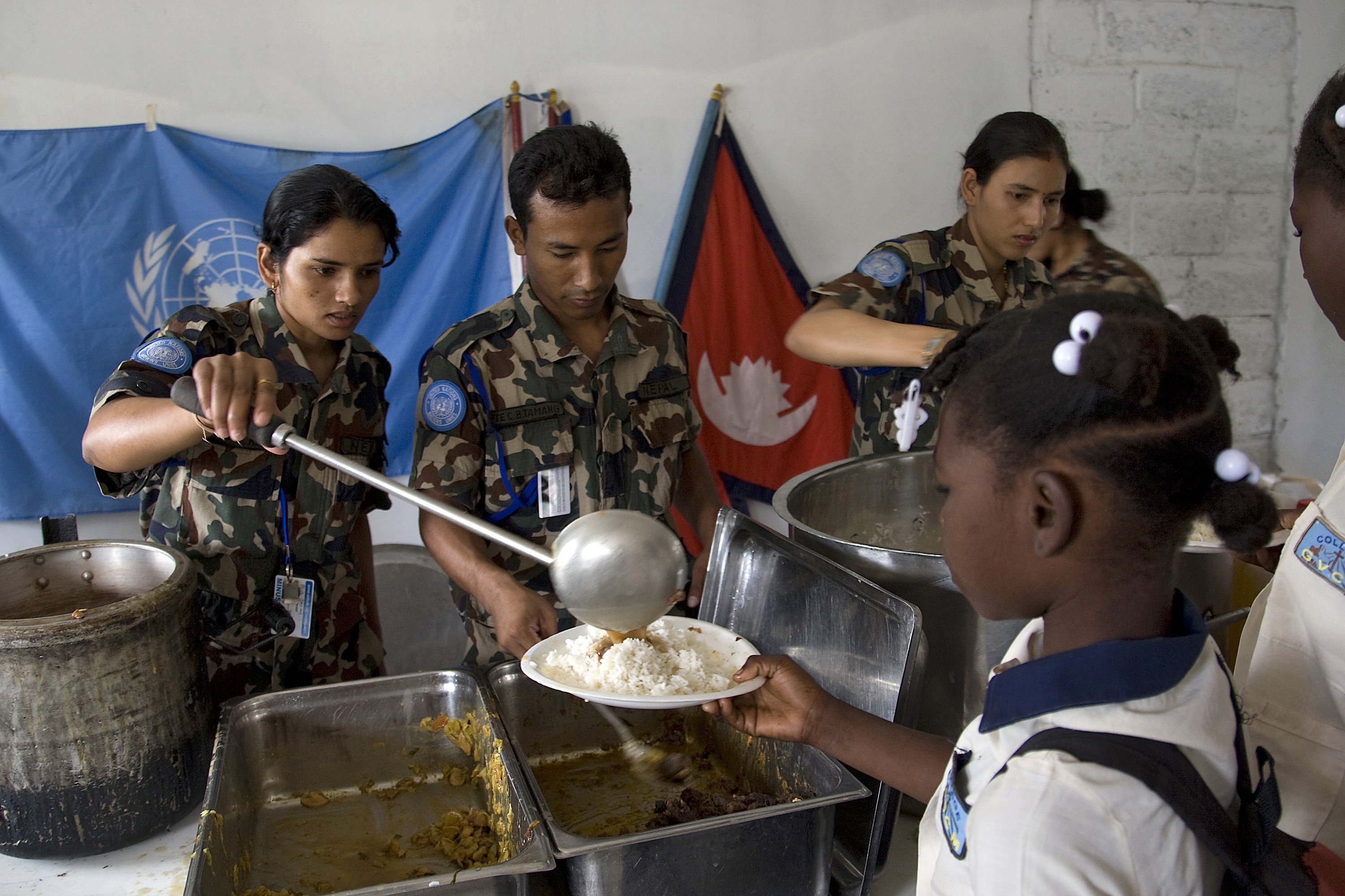UN peacekeepers serve food to people displaced by the earthquake in Haiti in January 2010