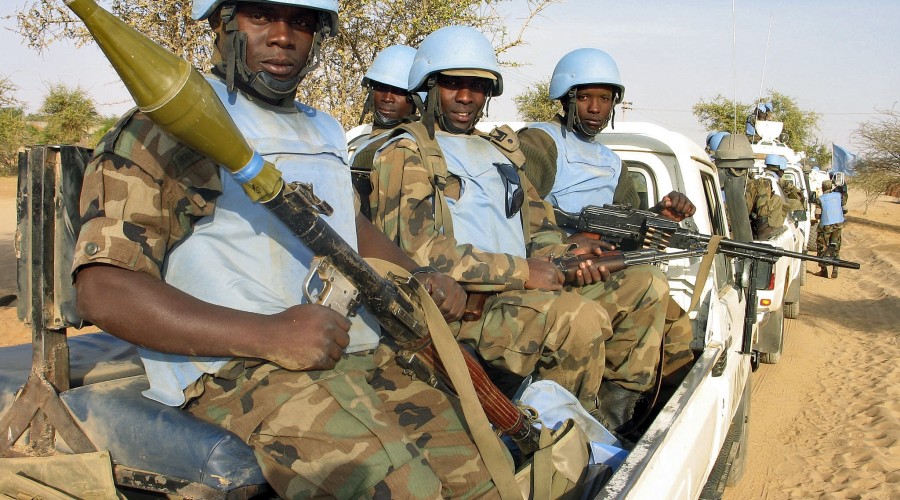 Soldiers from the joint African Union United Nations Mission in Darfur (UNAMID) peacekeeping force guard a supply convoy