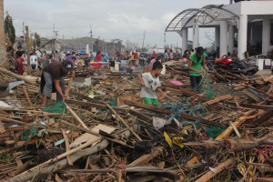 Filipinos in Tacloban, Philippines clear the streets after Typhoon Haiyan