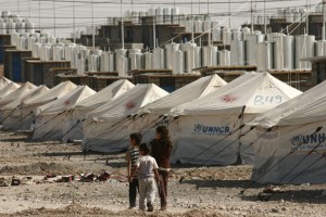Three Syrian refugee children explore the new camp at Darashakran in northern Iraq