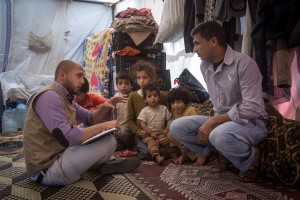 A Handicap International social worker assessing needs and vulnerabilities of a Syrian family recently arrived at Jibyanin refugee camp in the Bekaa Valley, Lebanon