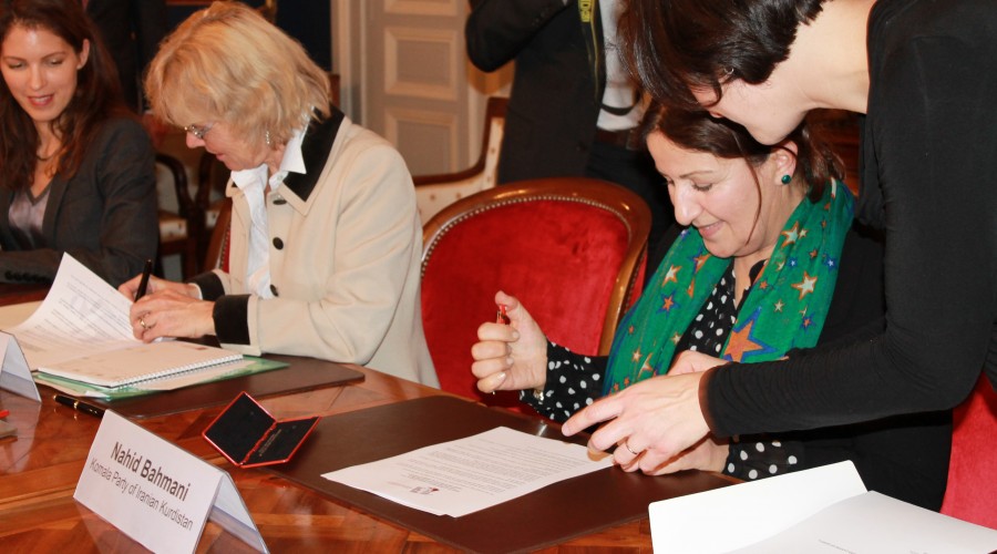 Geneva Call and a representative of the Komala Party of Iranian Kurdistan signing the Deed of Commitment prohibiting sexual violence and gender discrimination