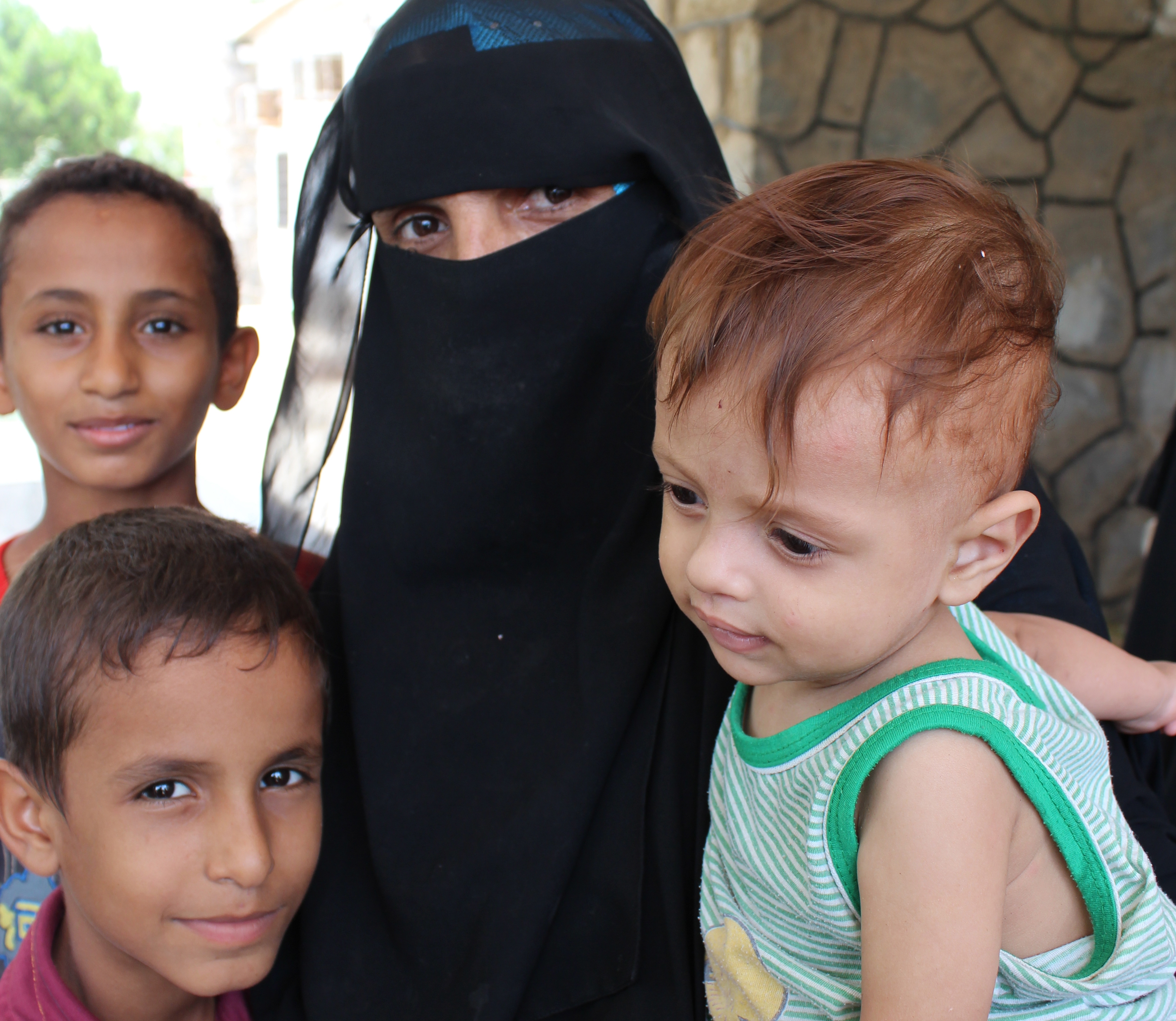A mother and her children at the Al-Buraiqa polyclinic in Aden, Yemen
