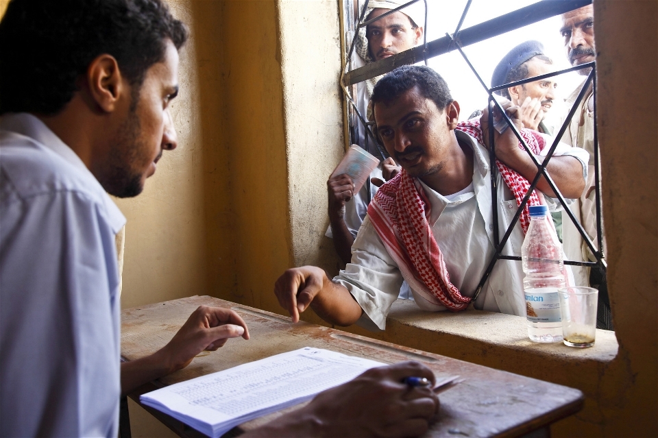 A man living outside Mazrak camp registers to receive food supplies from a WFP distribution centre