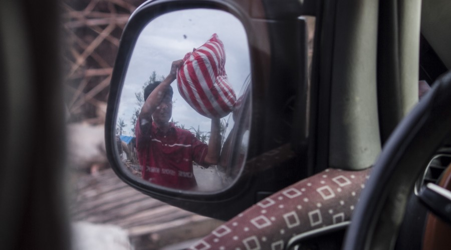 Pastor Fernand, of the Marabut Christian Community Church, unloads supplies in Leyte.