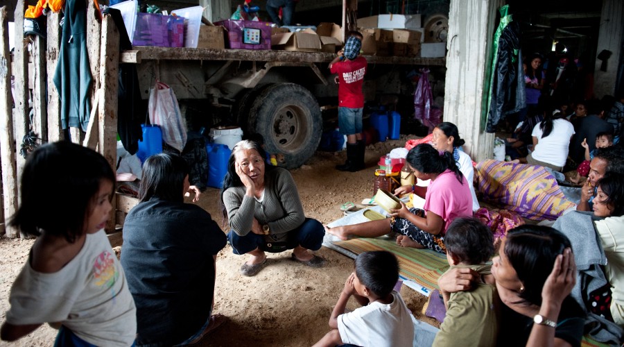 Families from Guiuan, Eastern Samar, set up camp at a local evacuation centre. Oxfam is working on WATSAN in two evacuation centres.