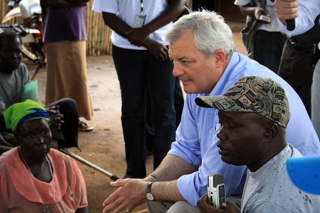 Stephen O'Brien, then UK Parliamentary Under Secretary of State for International Development, meets with people displaced by conflict in northern Uganda.