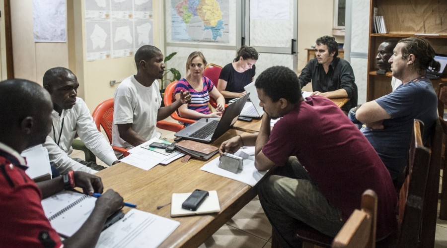 A team meeting of staff coordinating an Ebola treatment centre in Nzérékoré, Guinea