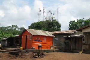 Phone mast and mobile shop at a road junction in Sierra Leone
