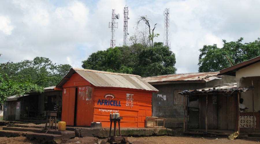 Phone mast and mobile shop at a road junction in Sierra Leone