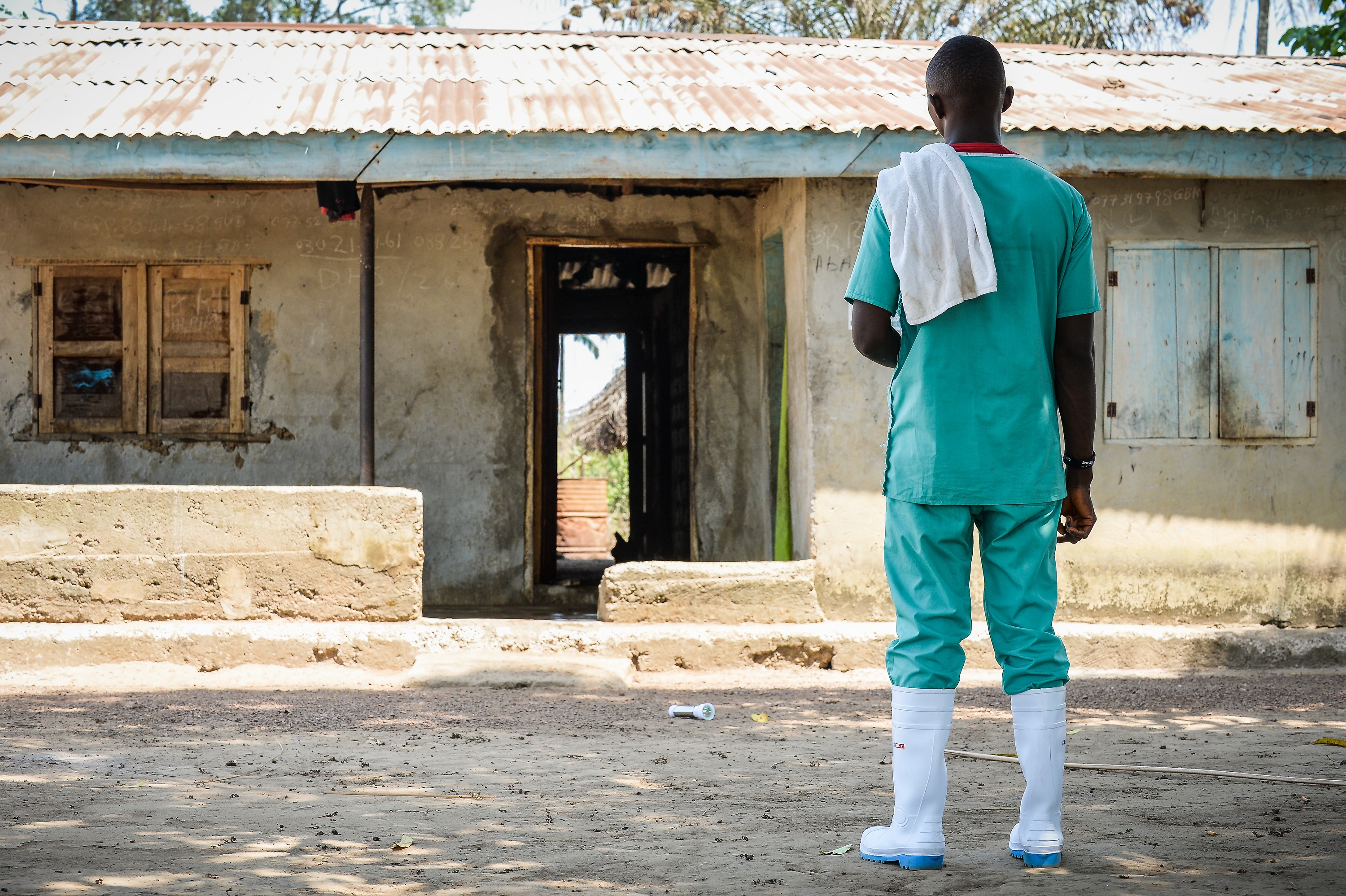 A member of a decontamination team at Makamie in Port Loko District, Sierra Leone