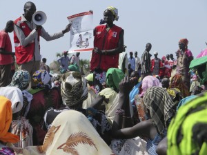 South Sudan Red Cross volunteers explain to a group of women how to prepare Super Cereal (full caption below)
