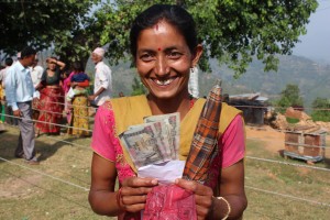 A woman receives a cash transfer via the Hello Paisa mobile money system.