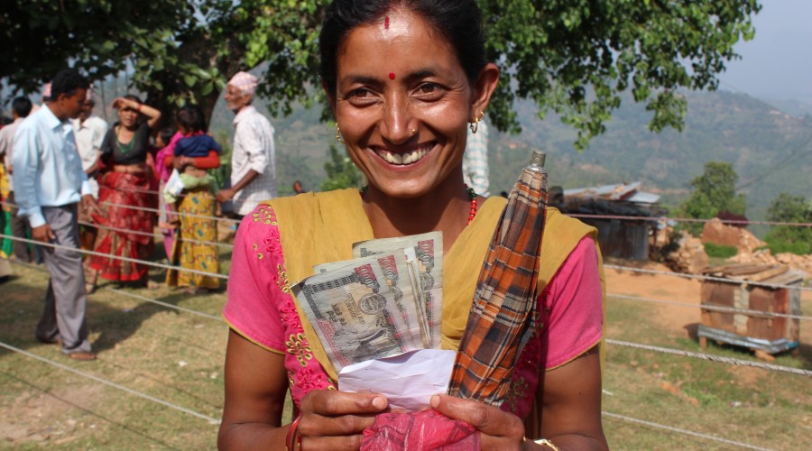 A woman receives a cash transfer via the Hello Paisa mobile money system.