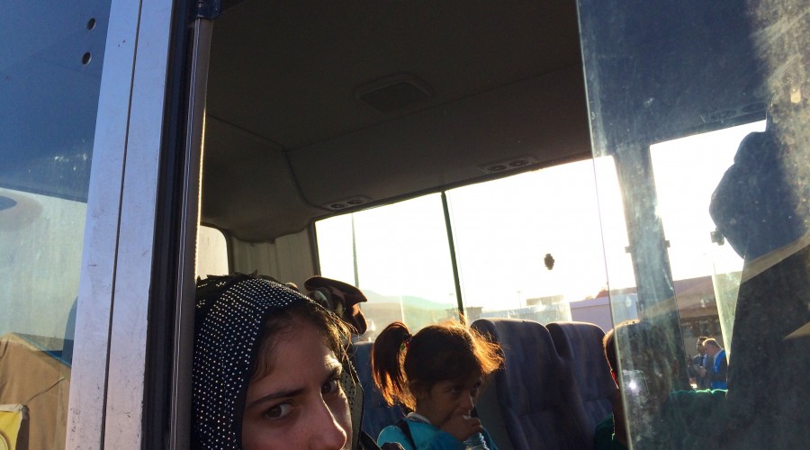 Families fleeing fighting in Kobane board IOM buses to Kurdistan