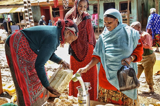 Beneficiary buying milk after receiving an HSNP cash transfer, Marsabit, Kenya