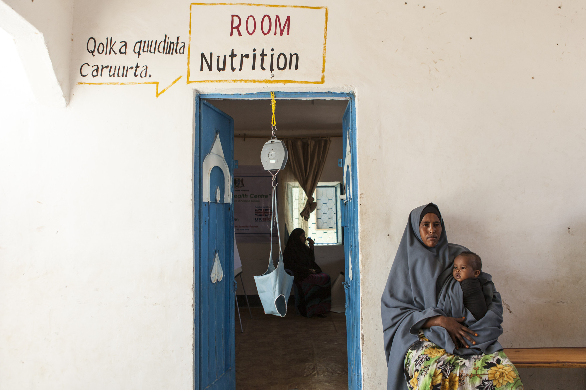 A mother holds her daughter at a health centre in the Karkaar region of Puntland, Somalia