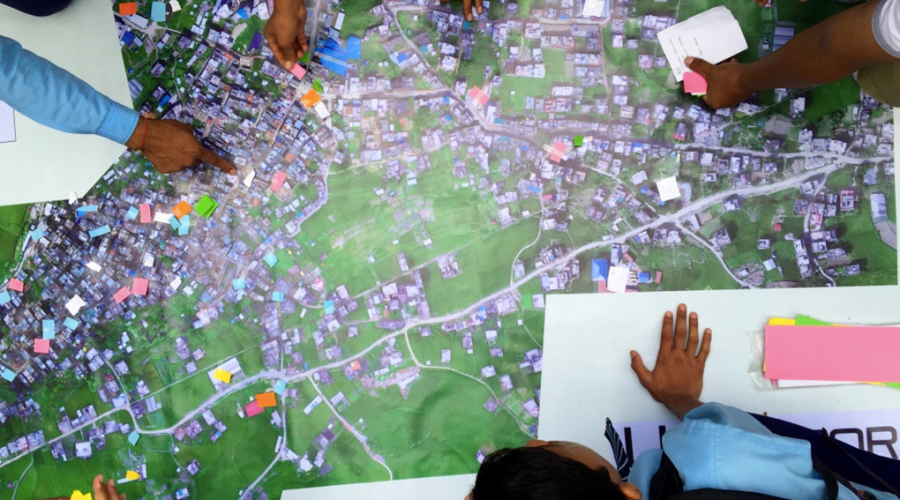 Residents of Panga, Nepal use aerial imagery to take part in a disaster damage assessment
