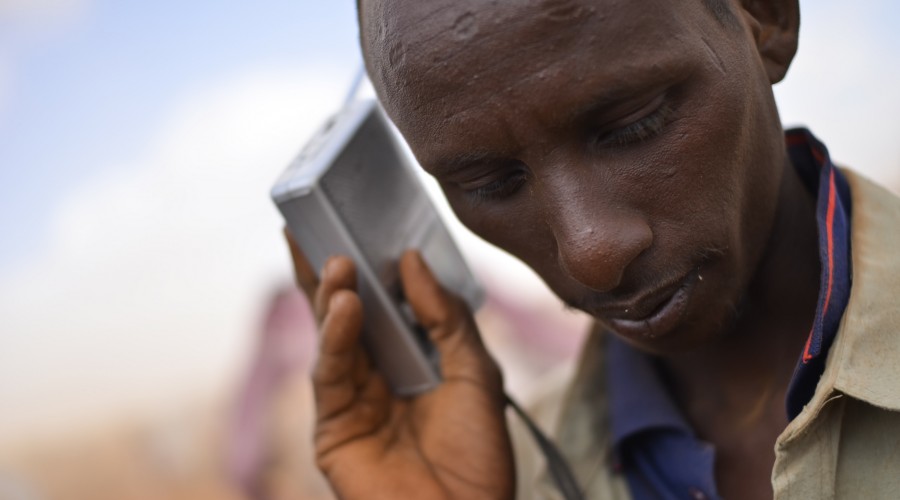 A man listens to a radio in the Ifo Extension refugee camp in Dadaab, Kenya
