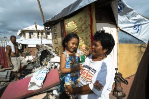 The Abas family in front of their devastated home in badly hit Tanauan, in Leyte.