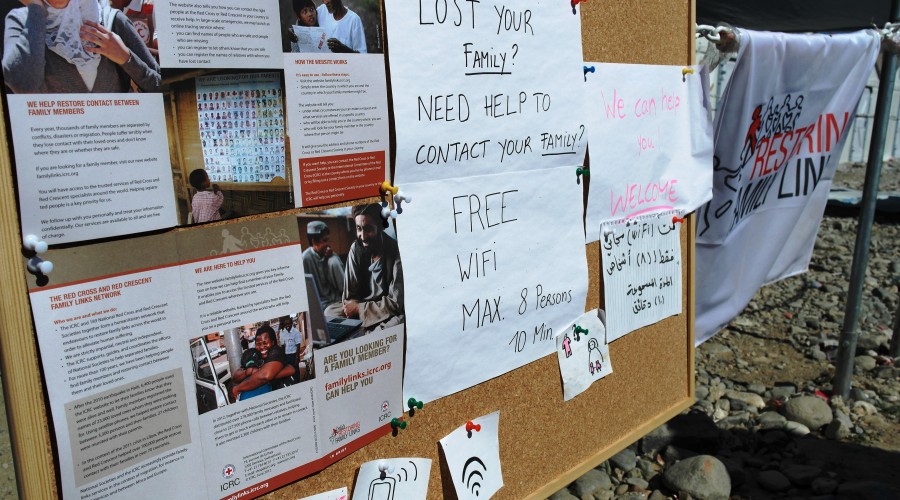 A Red Cross billboard giving information on family tracing services and Internet access at Gevgelija transit camp, Former Yugoslav Republic of Macedonia (FYROM).