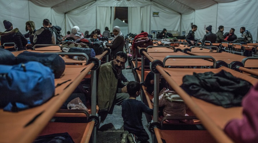 A refugee from Iraq rests with his family in an Oxfam shelter after arriving in Greece by boat from Turkey.