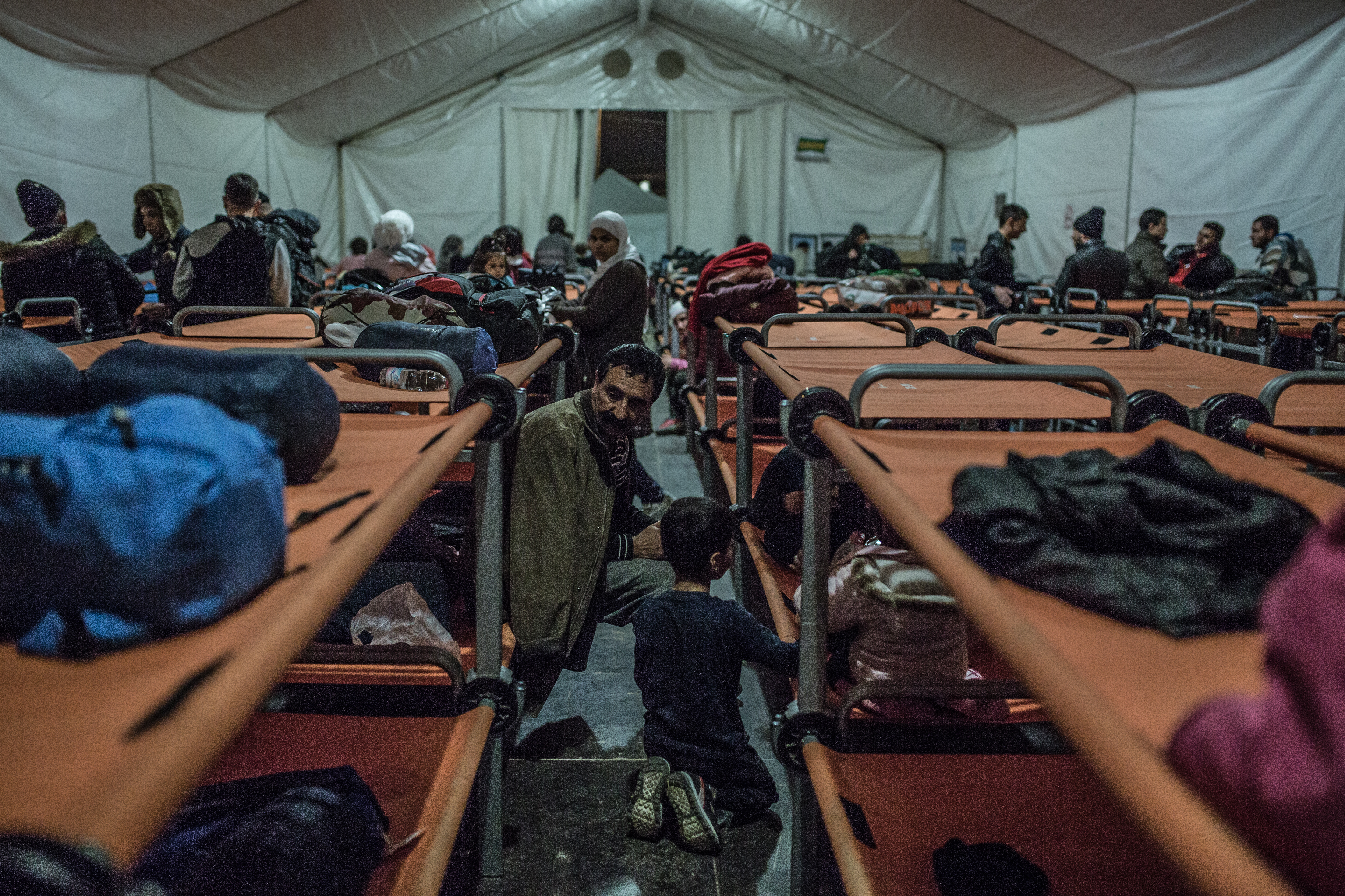 A refugee from Iraq rests with his family in an Oxfam shelter after arriving in Greece by boat from Turkey.