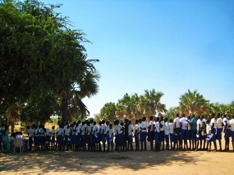 Schoolgirls in Warrap, South Sudan, queue to receive cash transfers at Tiit-Cok Primary School, Twic