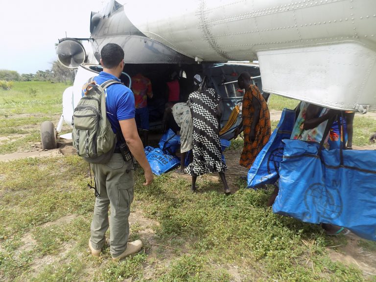 Survival Kits are offloaded from a UN Humanitarian Air Service helicopter in Nyakni Highland.
