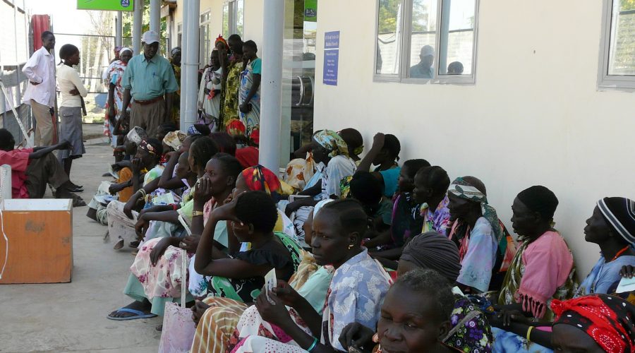People queuing with their cash vouchers outside a bank in South Sudan.