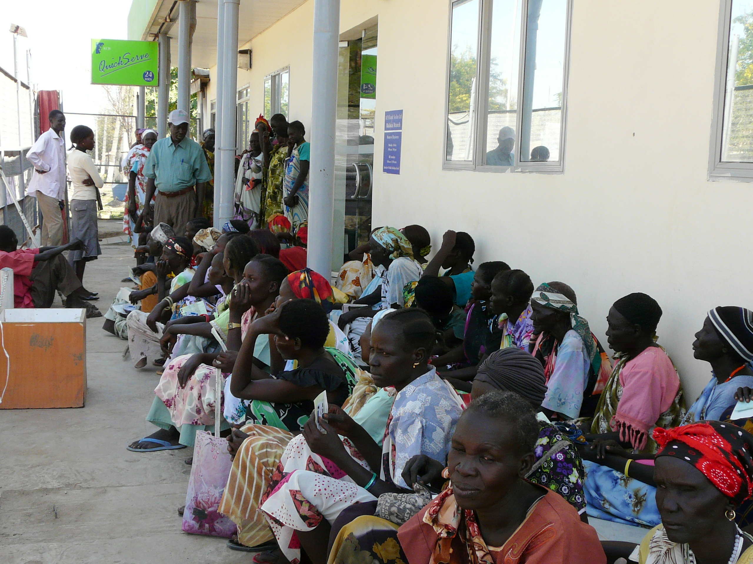 People queuing with their cash vouchers outside a bank in South Sudan.