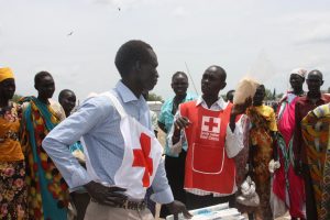 A member of the local Red Cross helping distribute much-needed food to vulnerable people, South Sudan