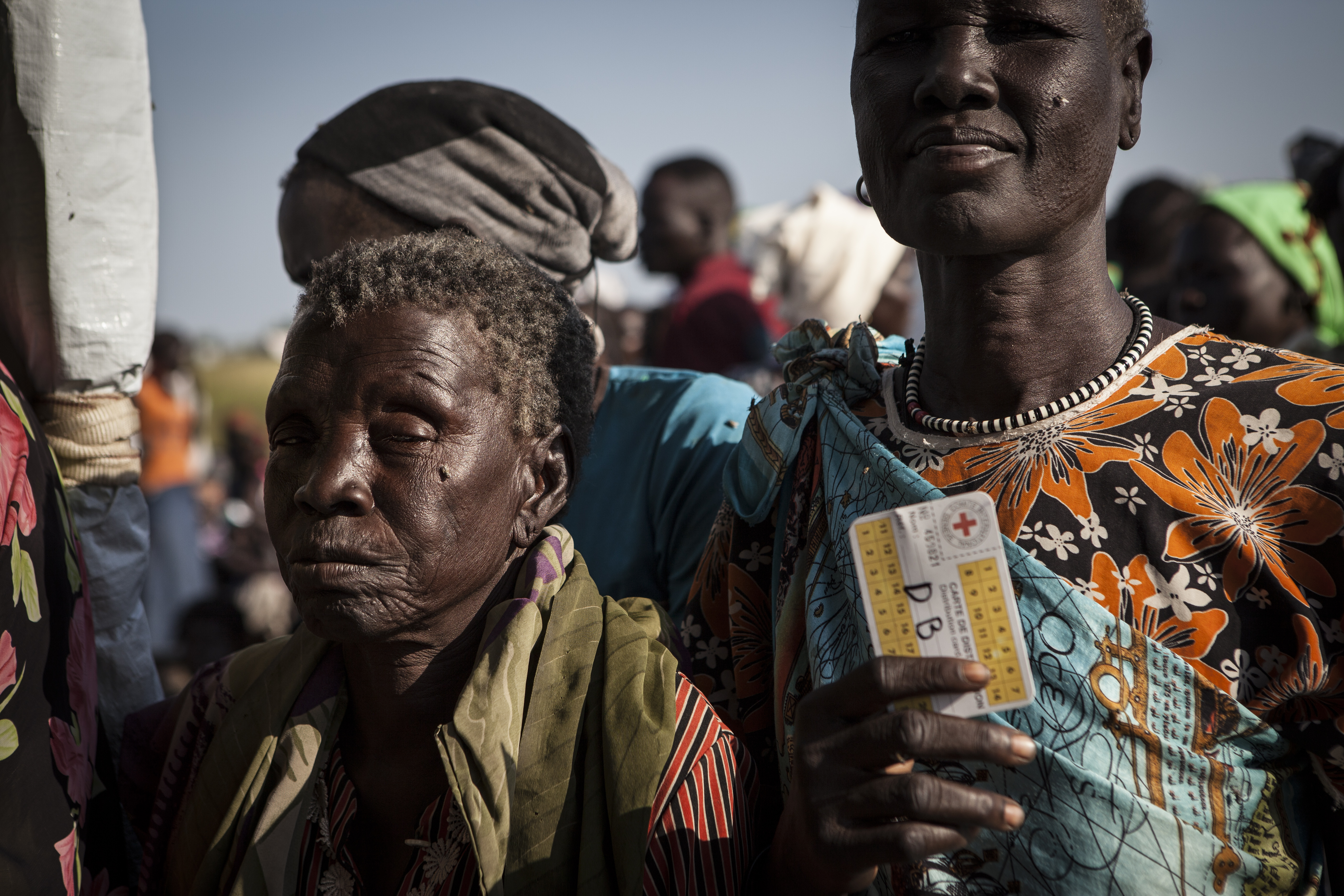 People with their registration cards for a food distribution in Jonglei State, Waat.